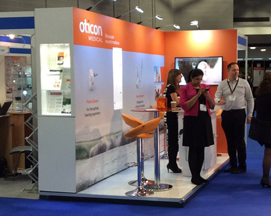Vibrantly coloured exhibition stand design with stools and tables for Oticon Medical