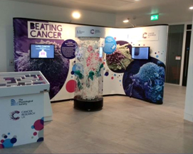 Visually engaging exhibition stand and informatative display screen for Cancer Research UK